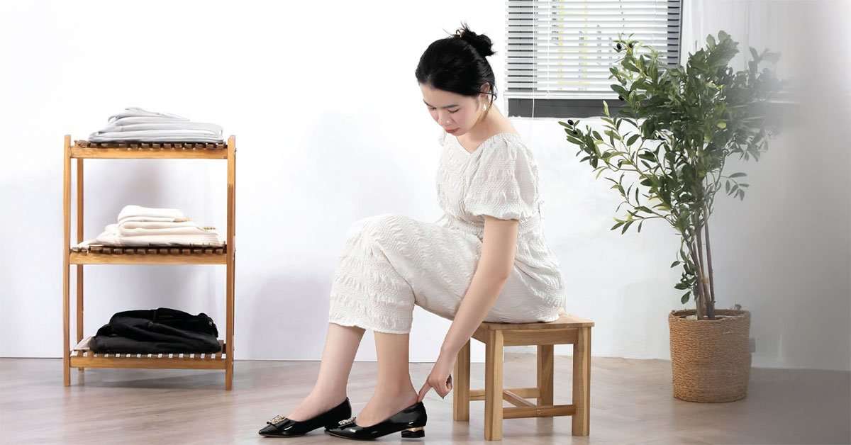 Compact 12-inch acacia step stool stored neatly under a kitchen counter