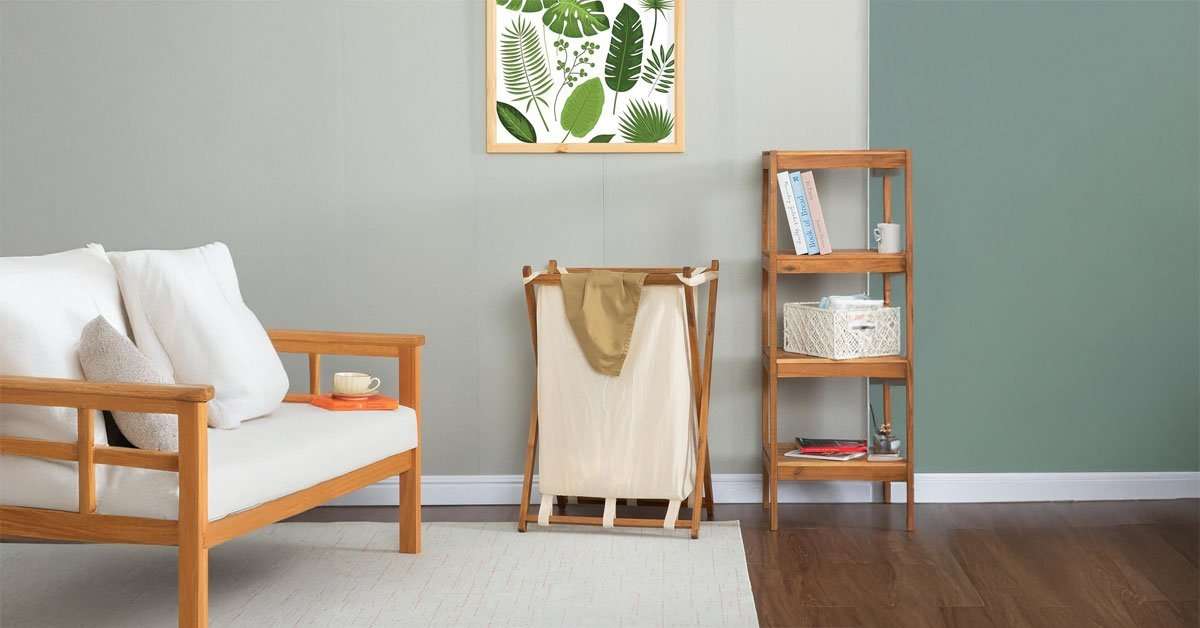 Removable cotton-linen laundry liner being lifted from the acacia wood hamper frame