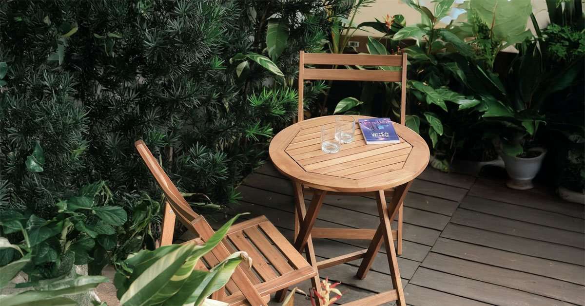 Acacia Wooden Folding Chairs Set of 2 for Patio & Garden 1 Set of 2 acacia wood folding chairs arranged on a garden patio in natural sunlight