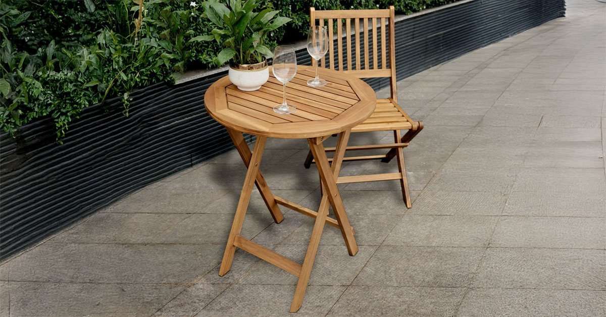 Foldable acacia round table used in an outdoor garden for casual dining