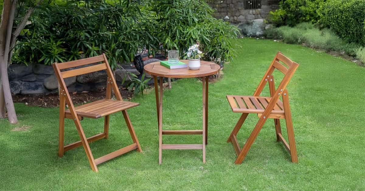 Foldable acacia round table with legs folded flat showing slim storage profile