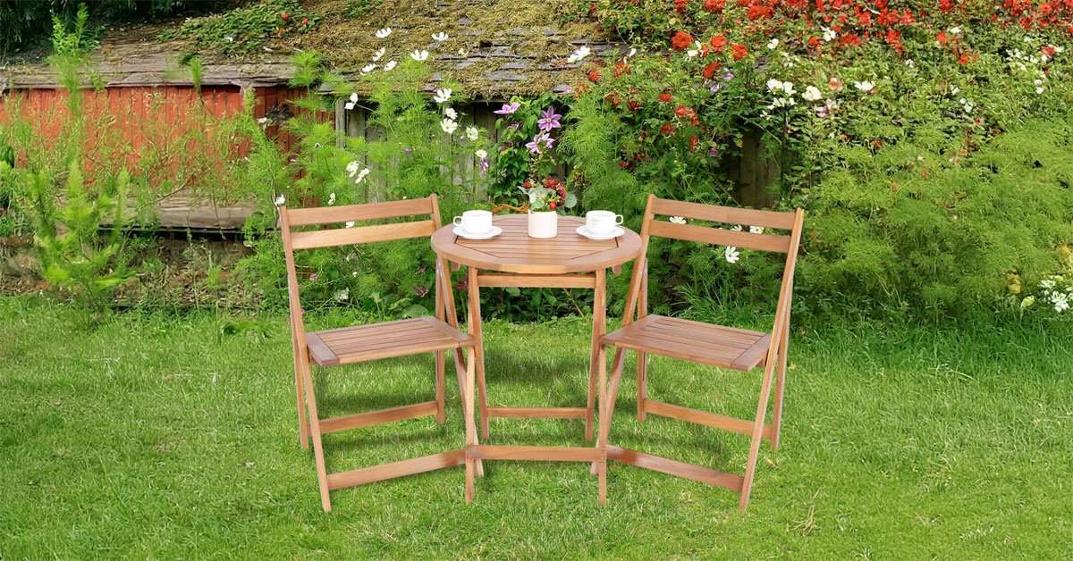 Foldable acacia wood round table with natural grain finish set up on an outdoor patio