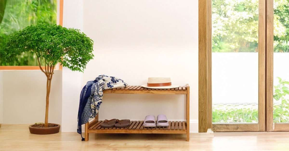 acacia wood shoe rack stackable units in an entryway with multiple pairs of shoes
