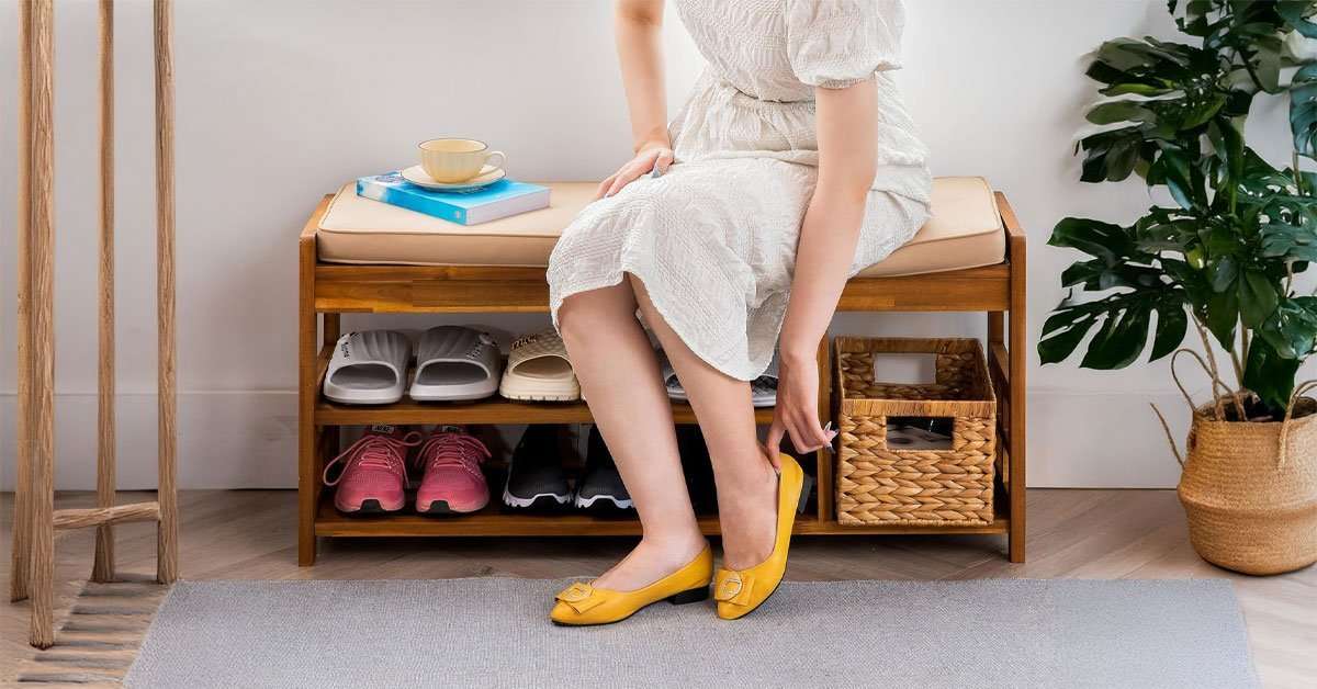 Wooden shoe bench in a closet used for organized shoe storage with seating