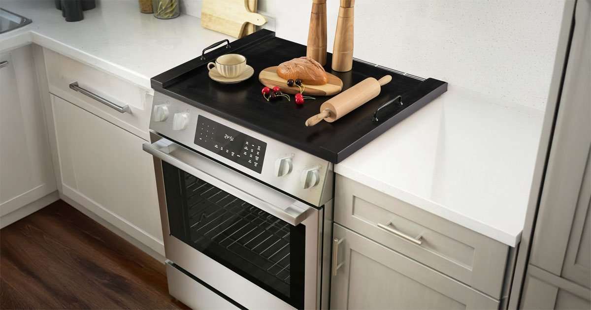 Noodle Board Stove Cover – Stylish Wooden Stove Top Cover & Kitchen Organizer 2 Wooden stove top cover used as cutting and serving surface in a kitchen