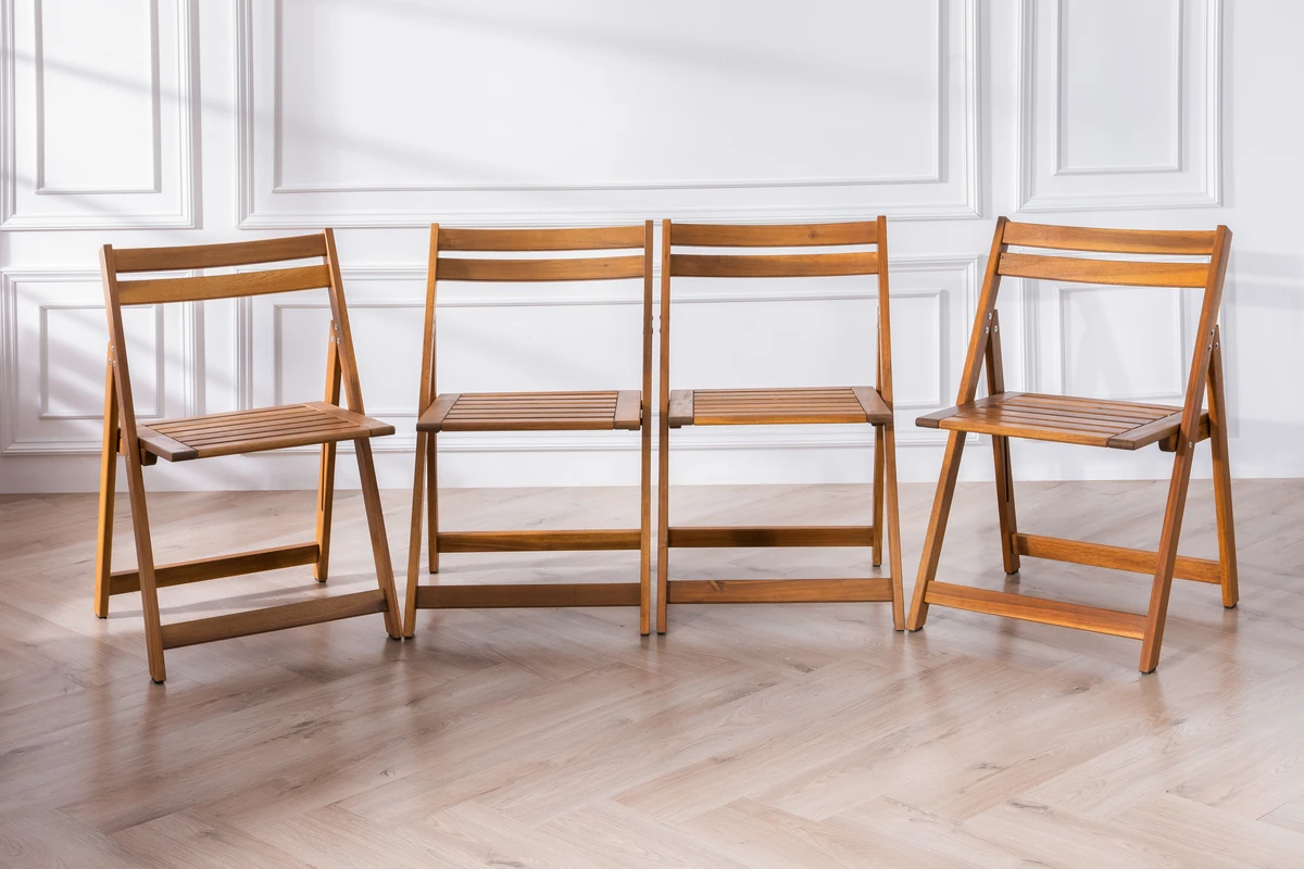 collection of acacia wood folding chairs displayed together
