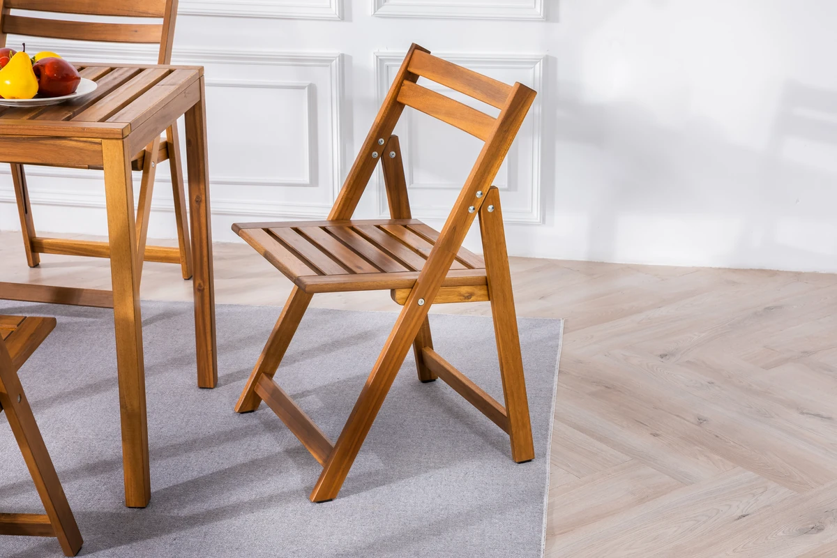 acacia wood folding chair beside a matching dining table