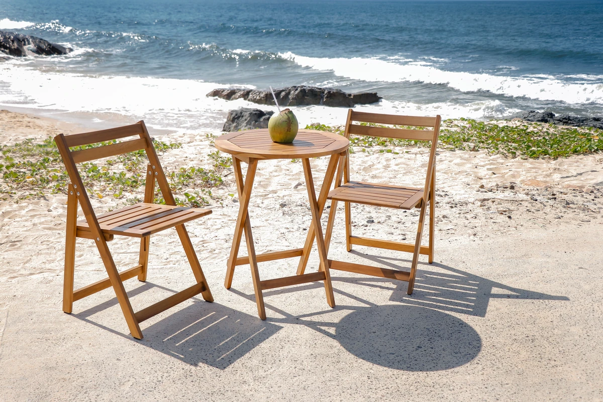 acacia wood patio dining set with two chairs near the beach