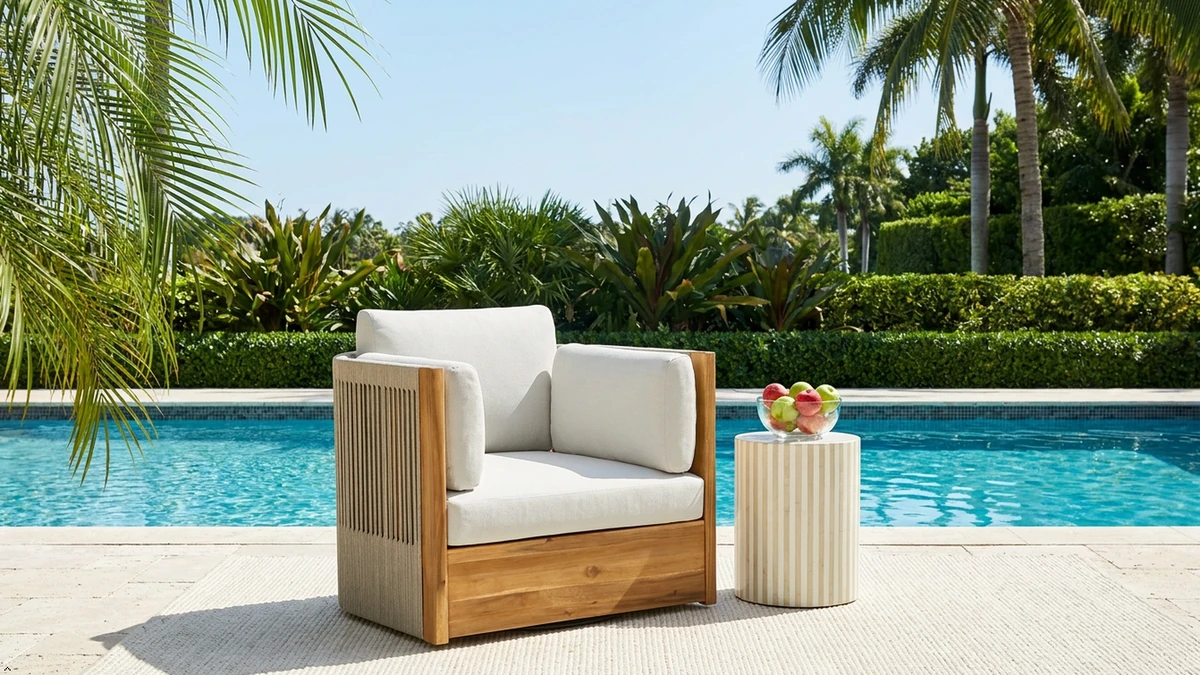Outdoor acacia swivel chair in a tropical poolside setting