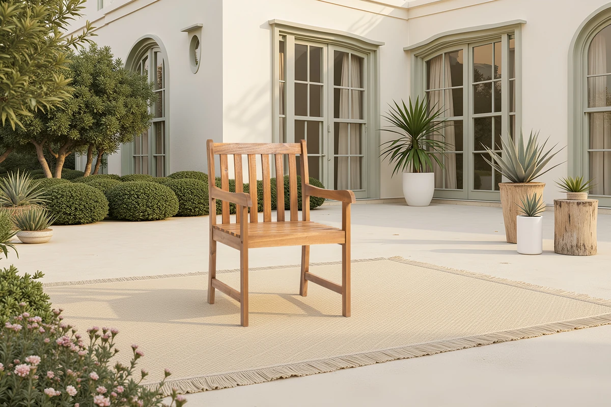 Solid wood patio dining armchairs on a bright covered patio