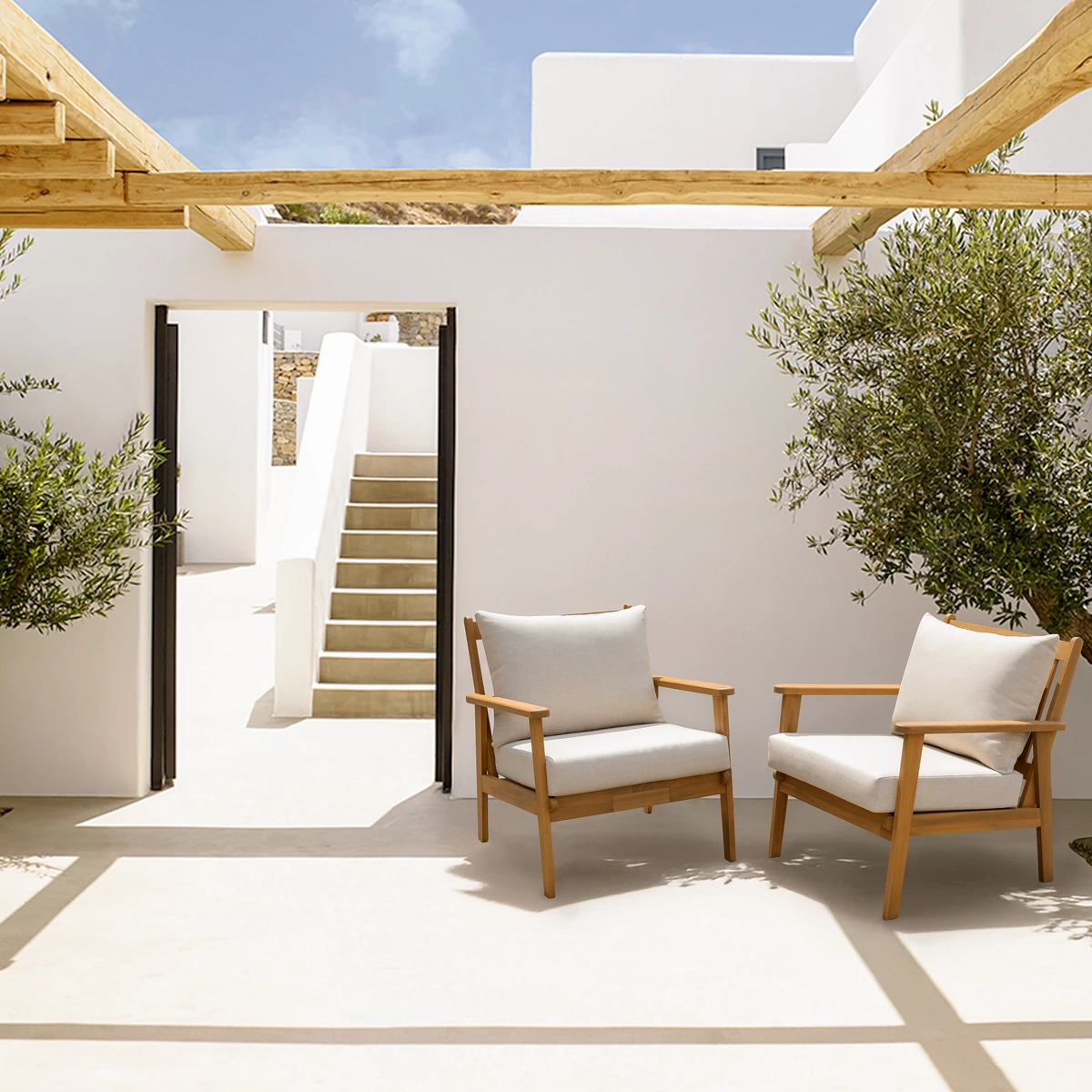 Two solid wood patio lounge chairs in a Mediterranean courtyard