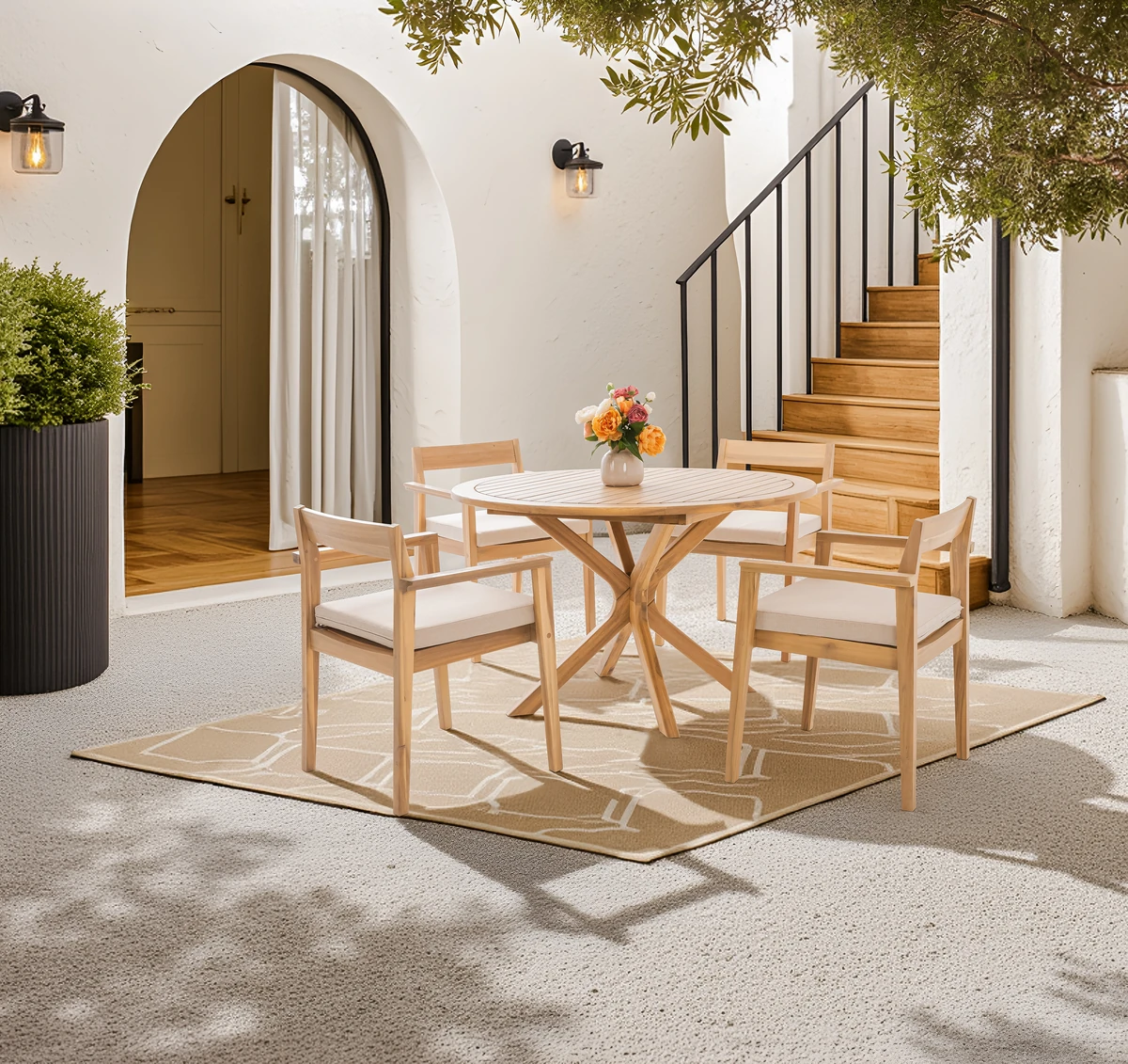 Round acacia patio dining set with four cushioned chairs