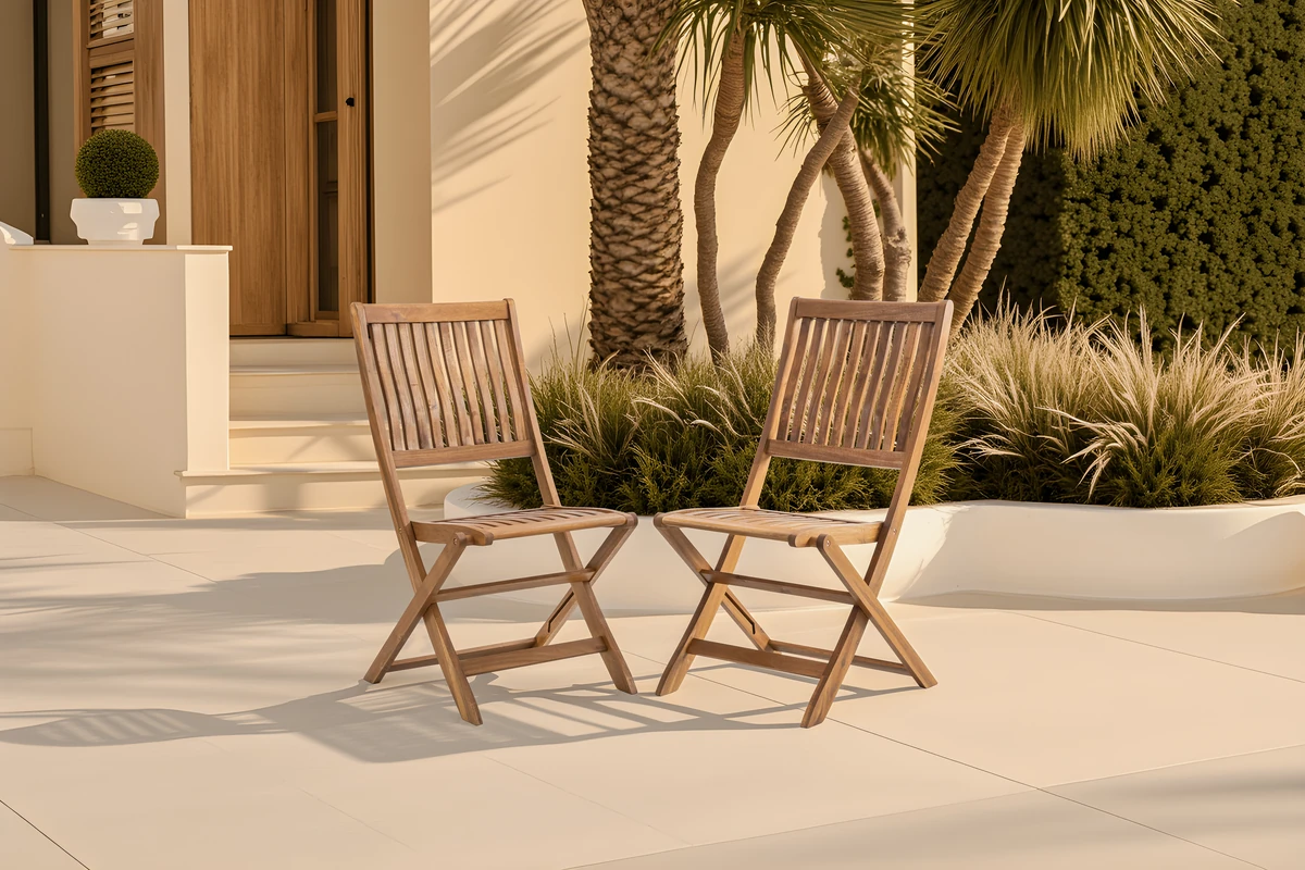 Two natural eucalyptus folding chairs in an outdoor seating area