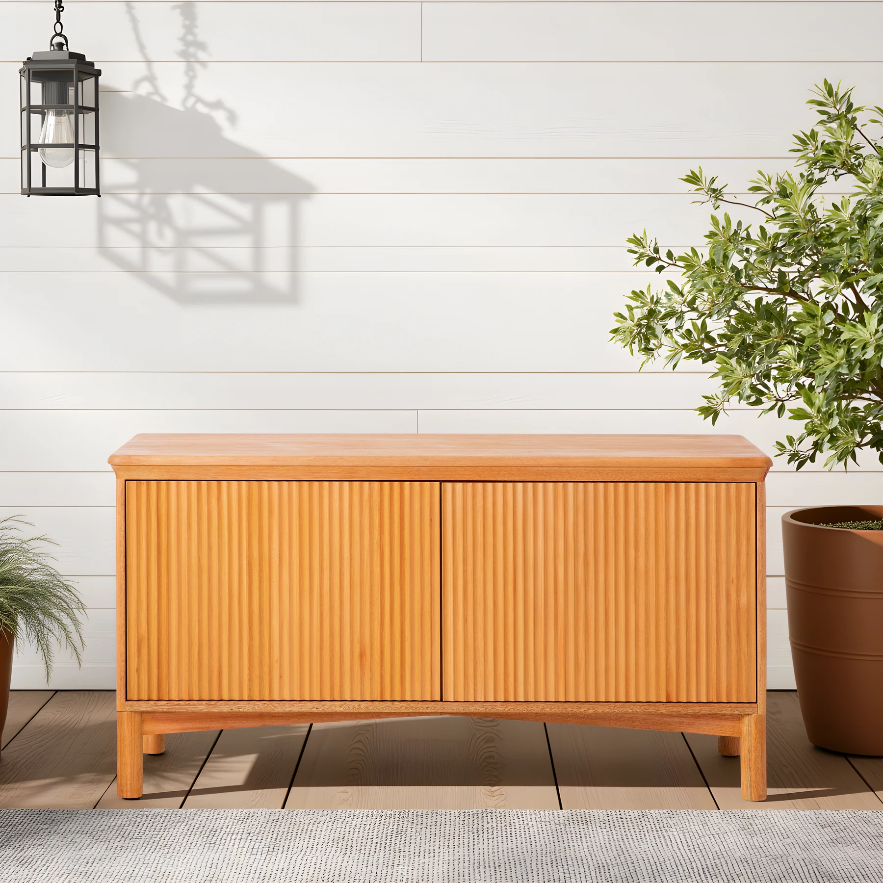 Eucalyptus outdoor sideboard on a covered patio styled with outdoor furniture