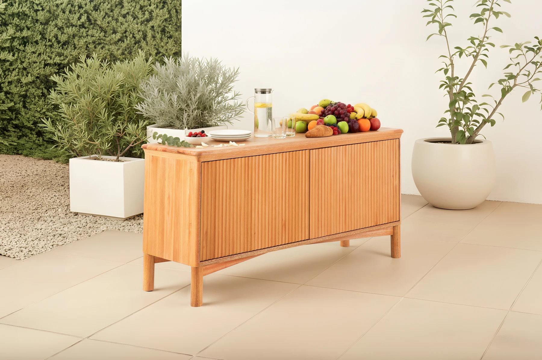Eucalyptus outdoor sideboard styled on a patio with matching outdoor furniture