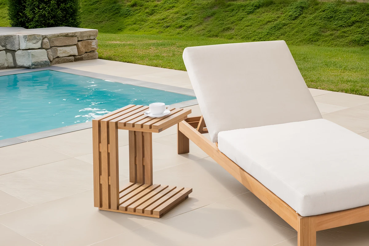 Eucalyptus side table next to a cushioned outdoor sun lounger