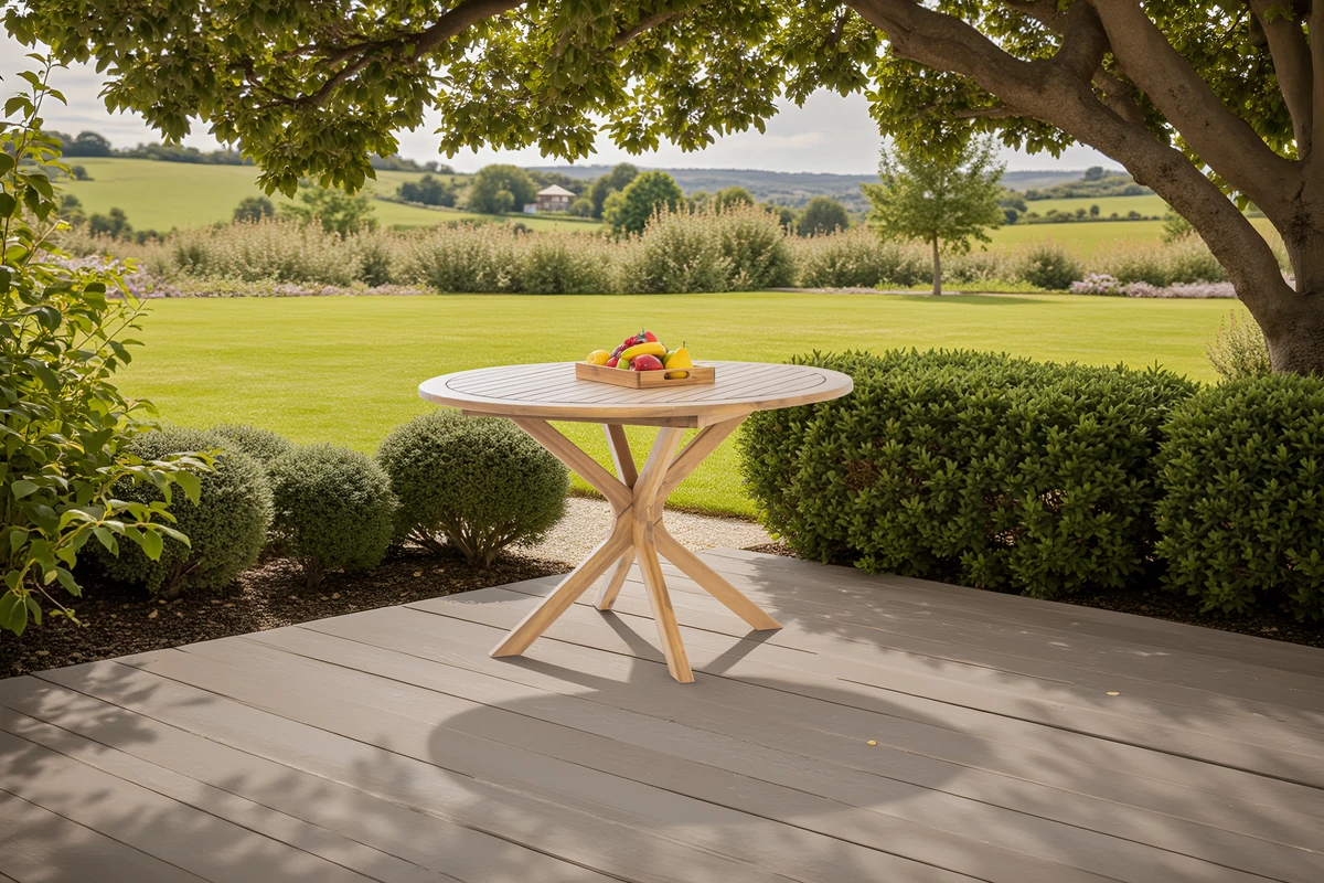 Round acacia wood outdoor table on a garden patio