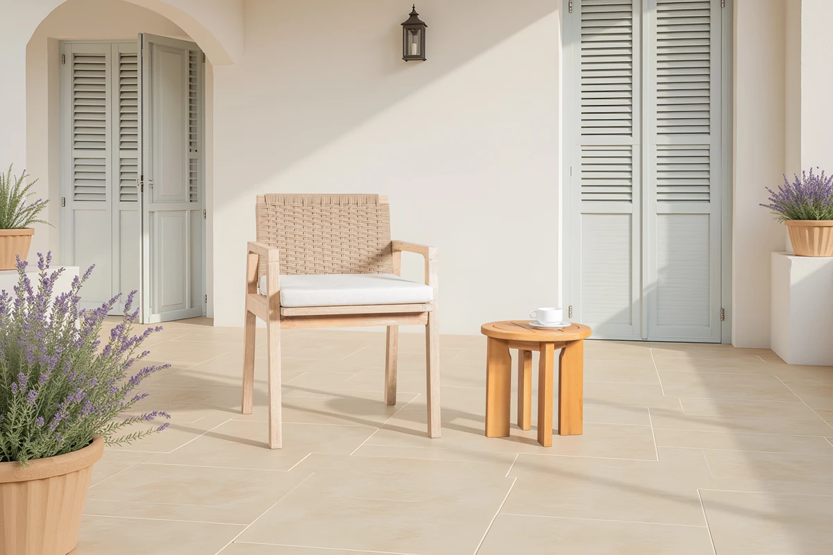 Natural round patio side table beside a patio chair