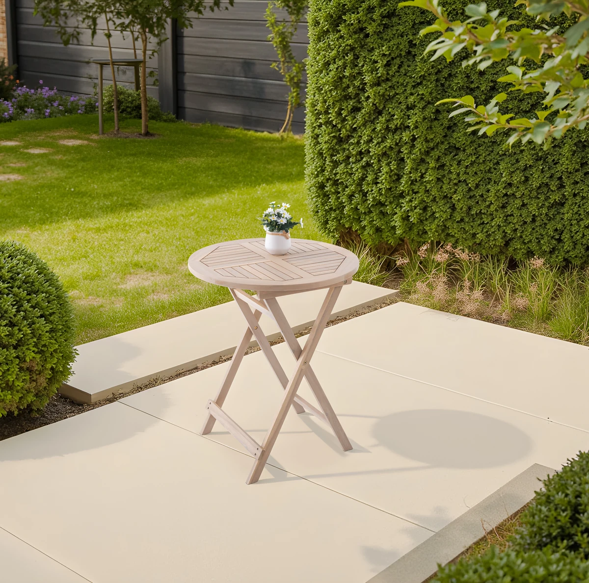 White Wash wood patio folding table in a garden setting
