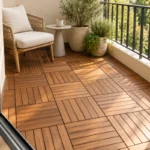 Small balcony deck tile ideas with warm acacia flooring, a cream outdoor chair, a coffee table and green plants.